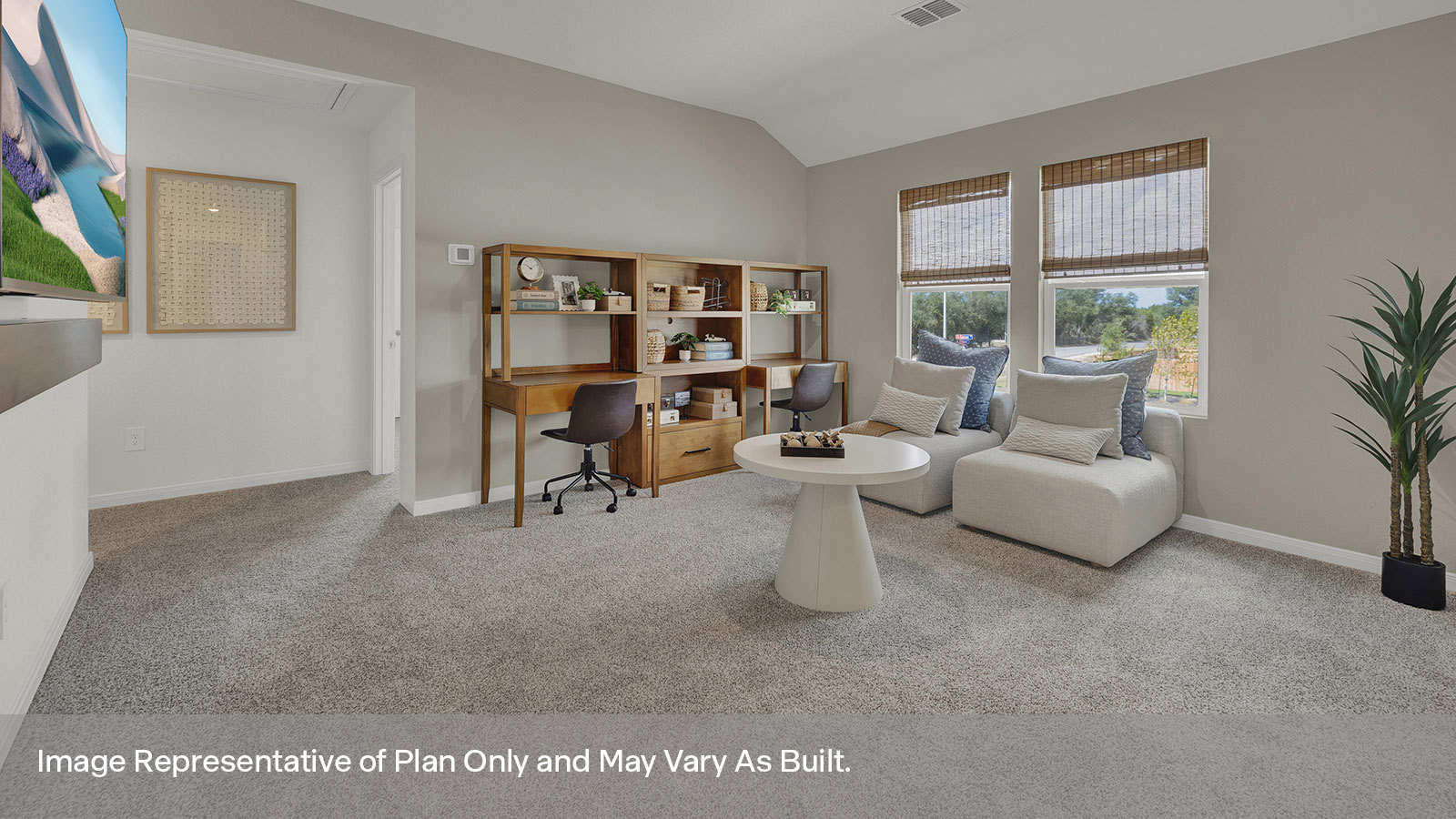 Gameroom of off the staircase with carpeting and two windows.