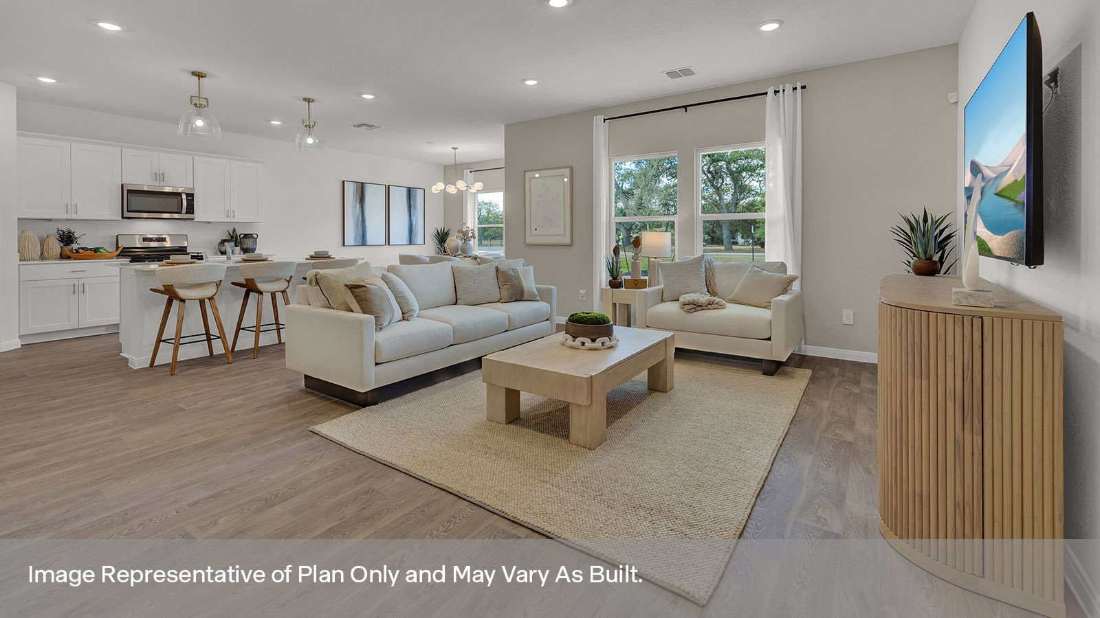 Living room with vinyl flooring and two windows opening to the kitchen.
