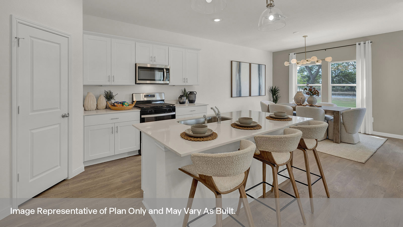 Kitchen with kitchen island and stainless steel appliances.