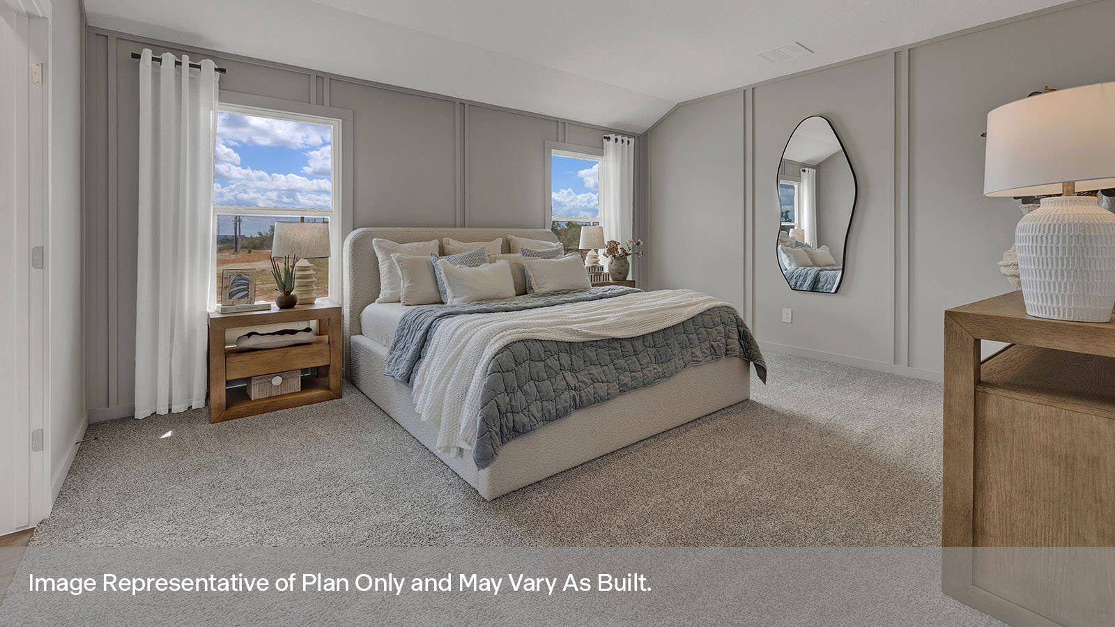 Main bedroom with carpeting and two windows.