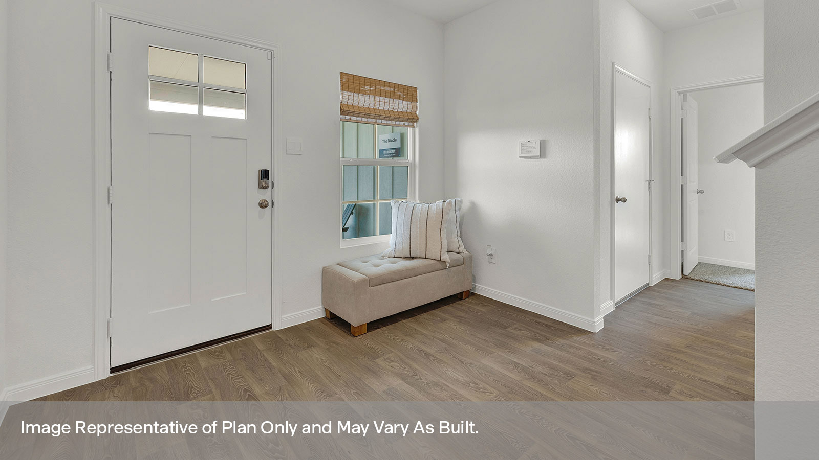 Entry hallway with vinyl flooring and front door.