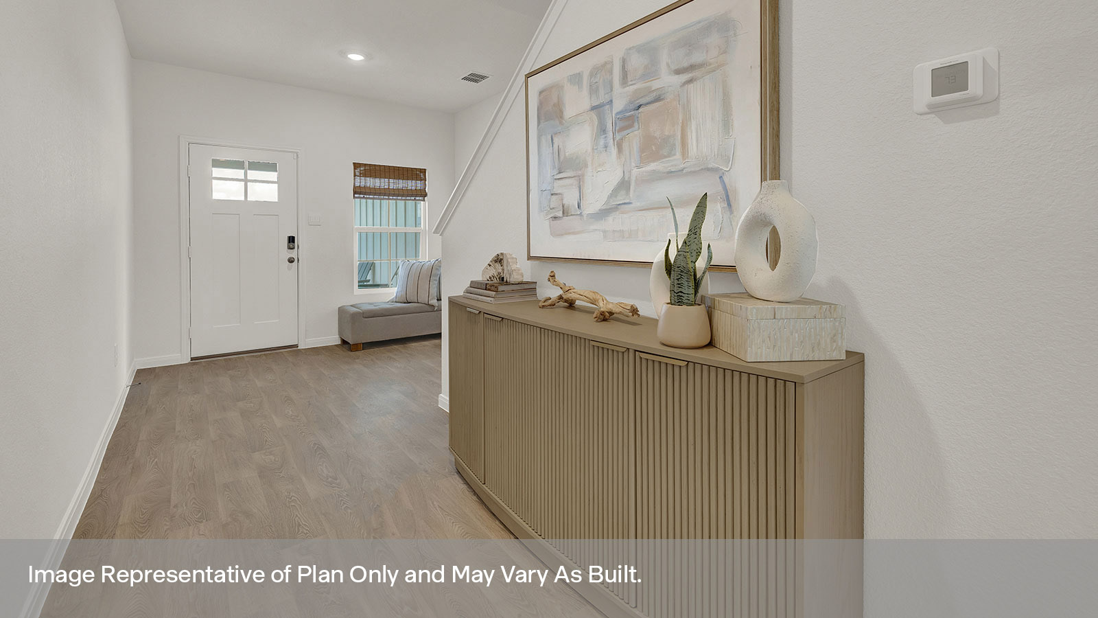 Entry hallway with vinyl flooring and front door.