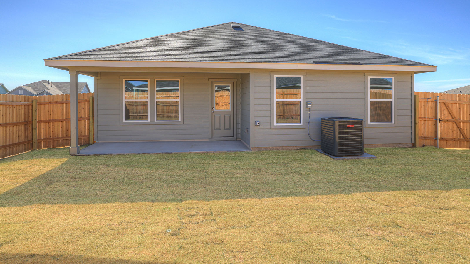 covered patio with fully sodded yard