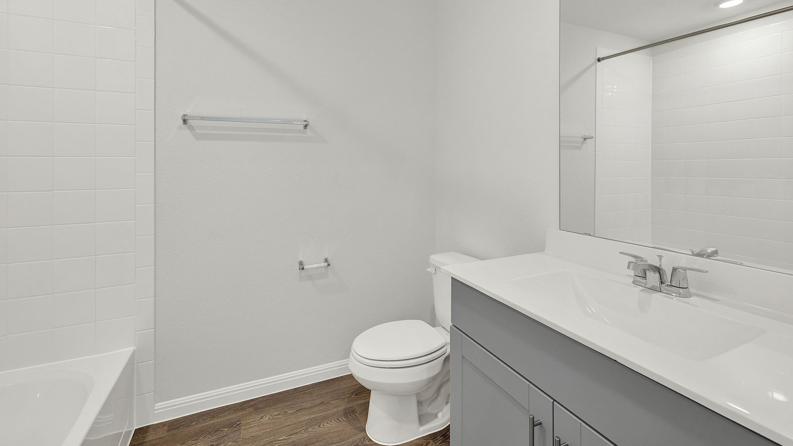 hall bath with vanity, toilet and shower tub combo