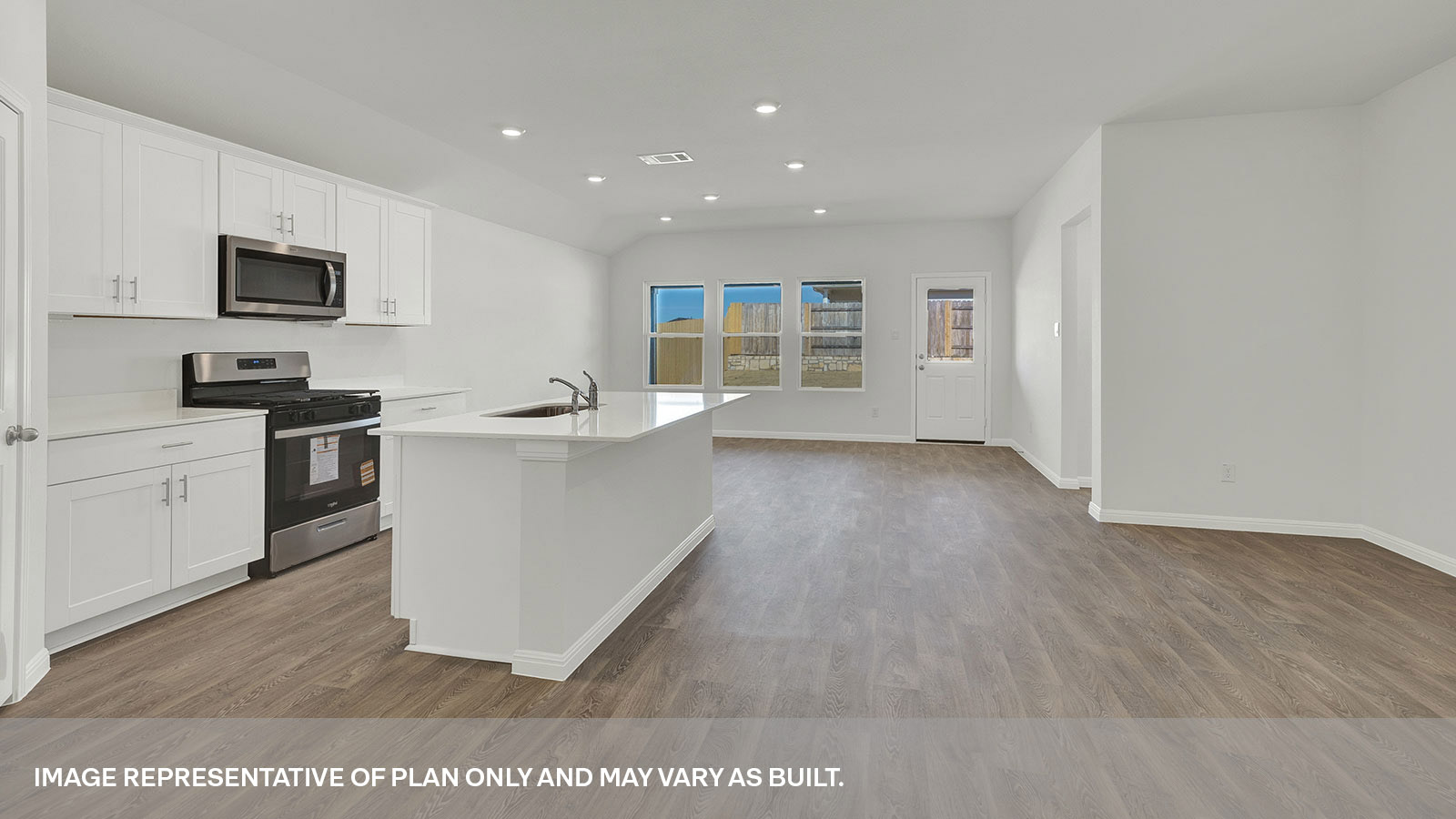 Kitchen with kitchen island and entry hallway.