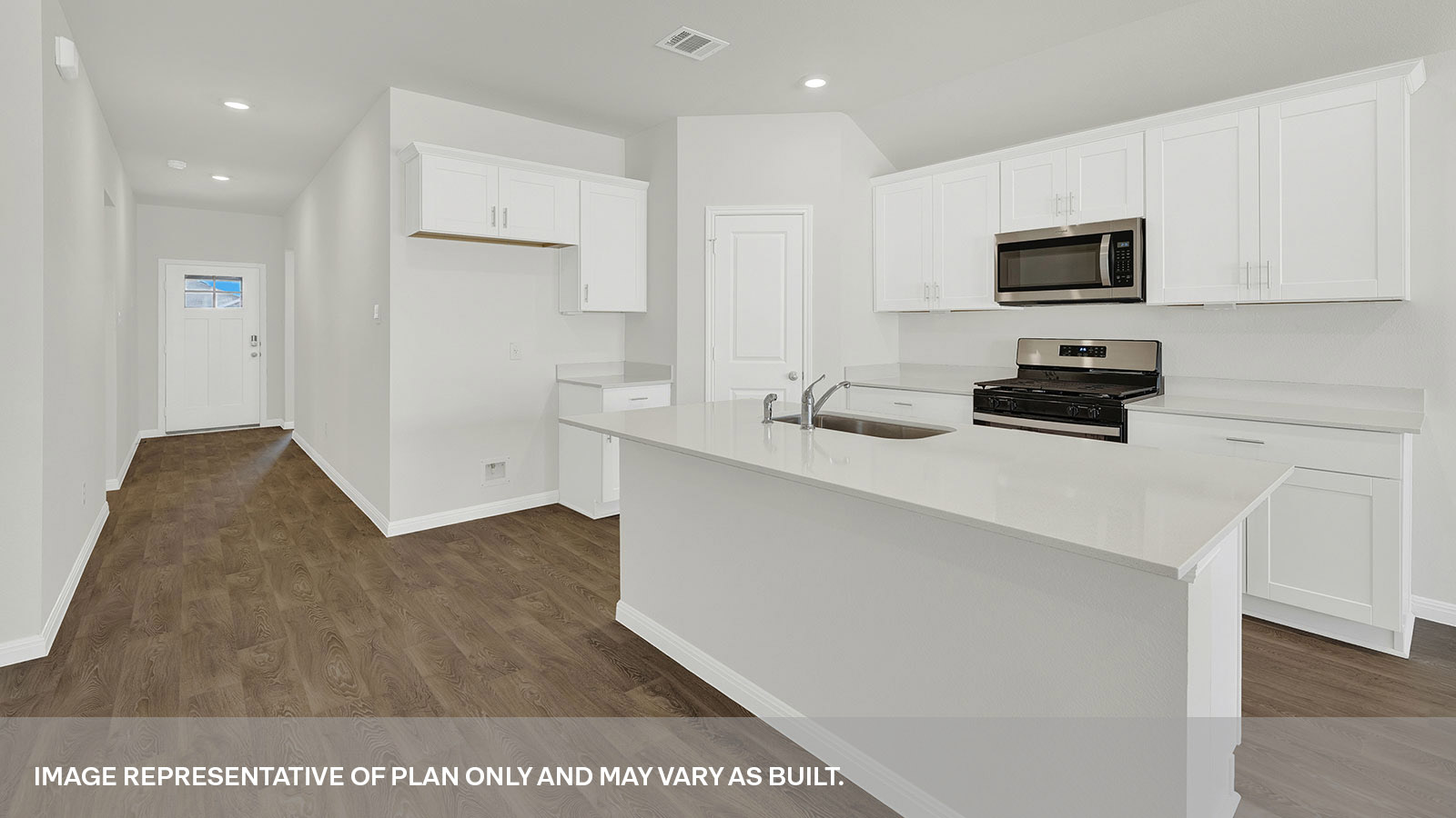 Kitchen with kitchen island and entry hallway.
