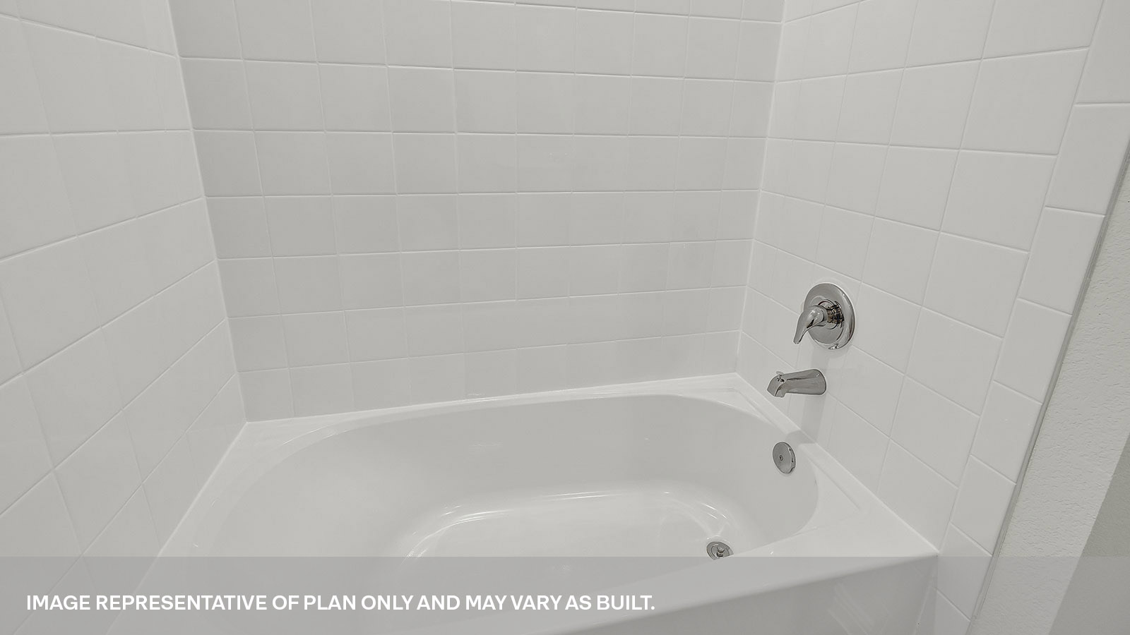 Hall bathroom tub with tile surround.