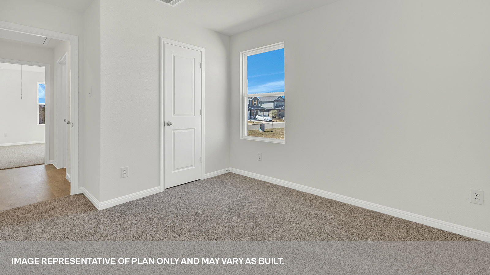 Bedroom with carpeting and one window looking into the side yard.