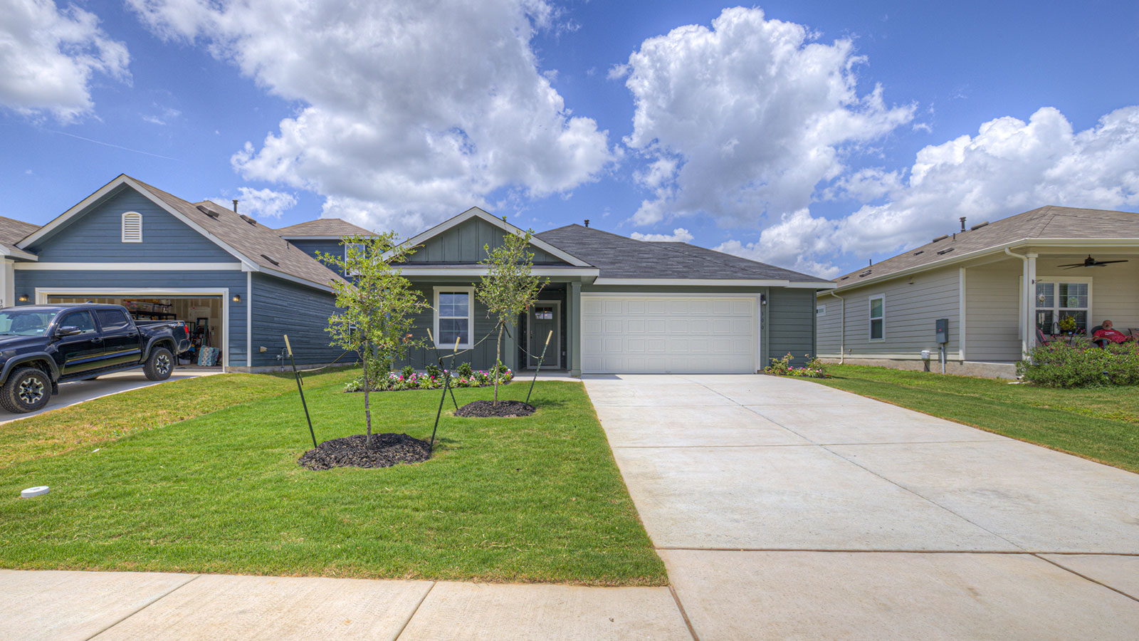 .Single-story farmhouse rendering with farmhouse exteriors, one window, and a 2 car garage.