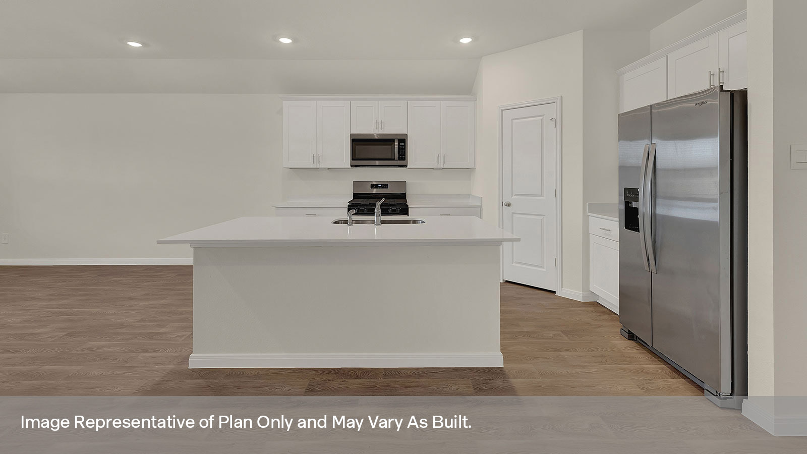 Kitchen with kitchen island and whitecabinets.