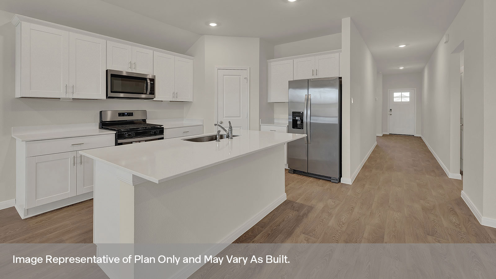 Kitchen with kitchen island and entry hallway.
