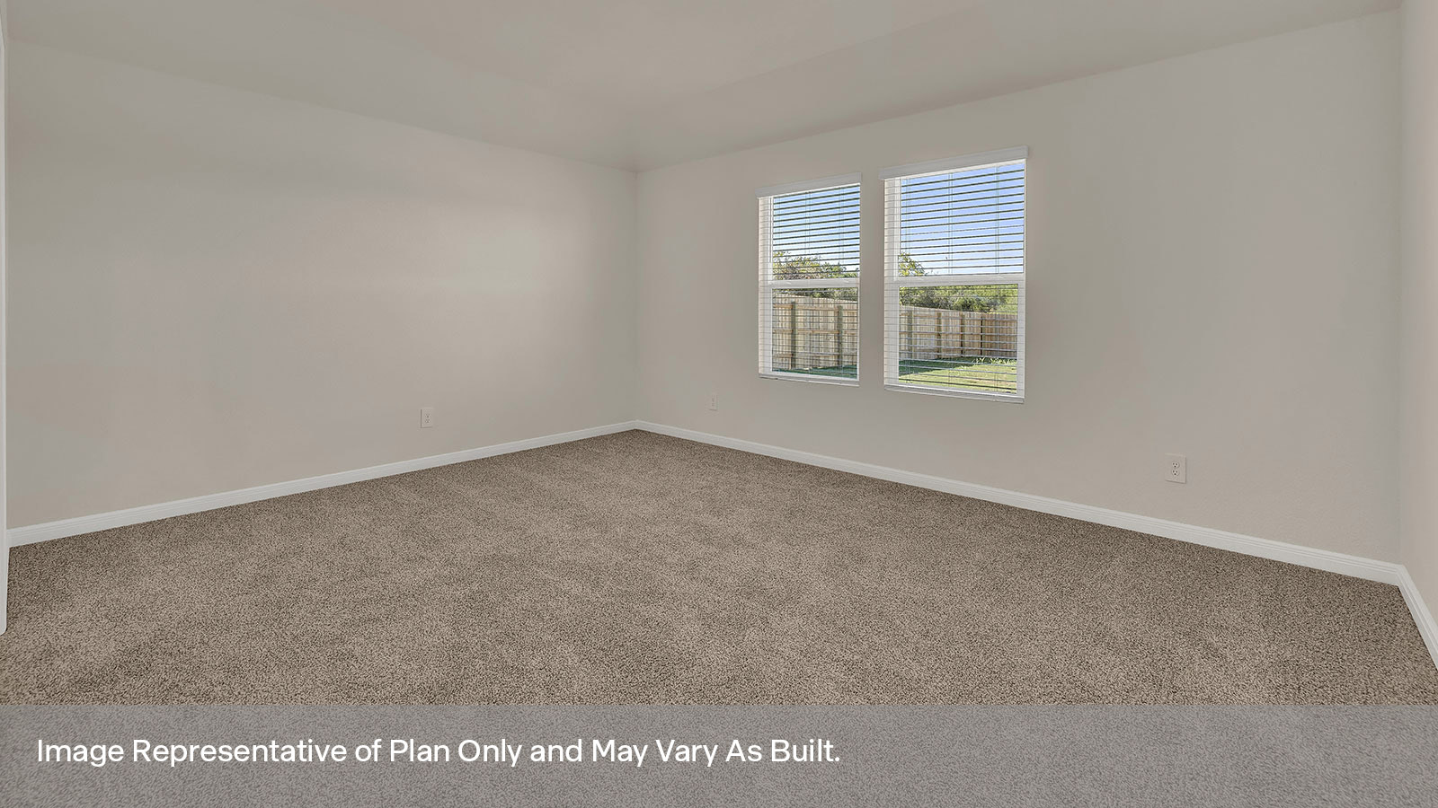 Main bedroom with carpeting and two windows.