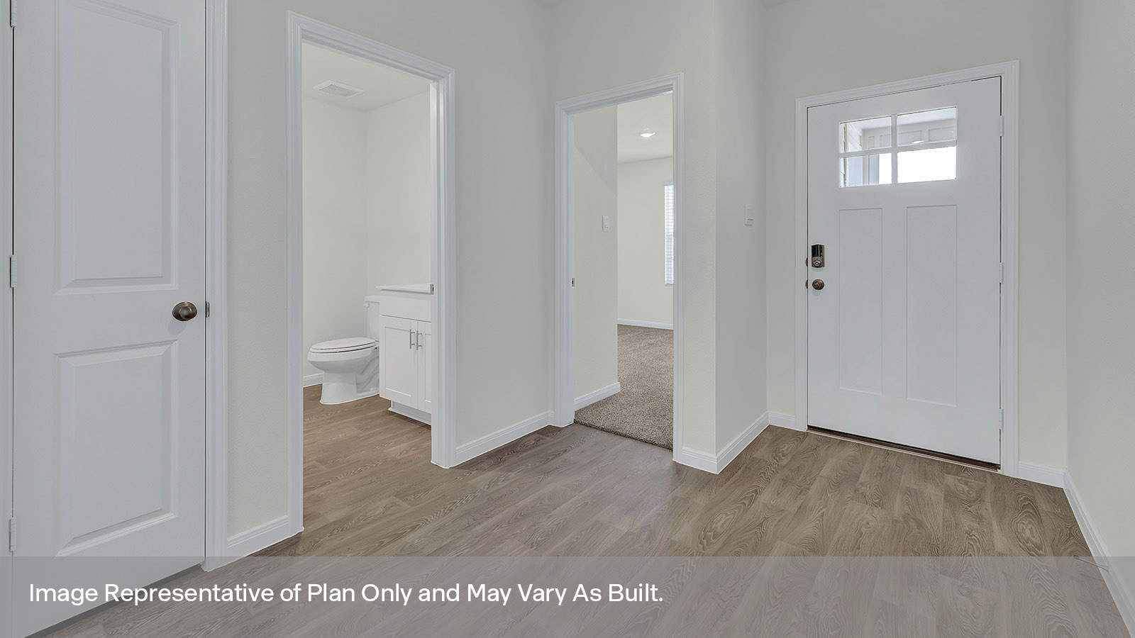 Entry hallway with bedroom entrance and front door.