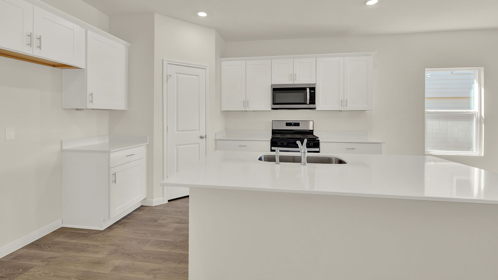 Kitchen with kitchen island and stainless steel appliances.