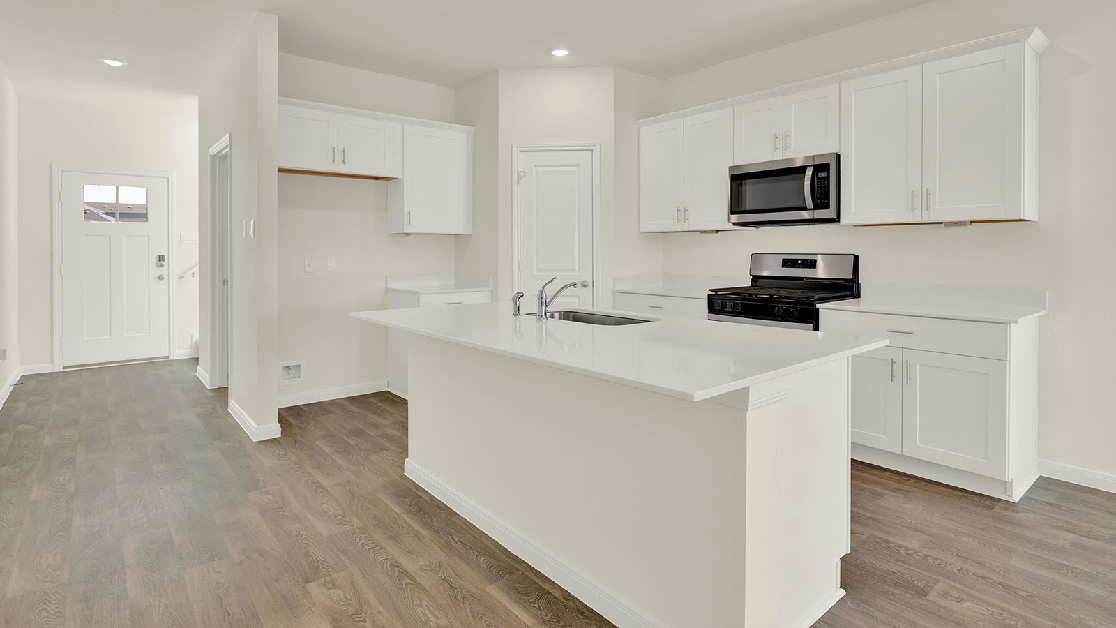 Kitchen with kitchen island and stainless steel appliances.