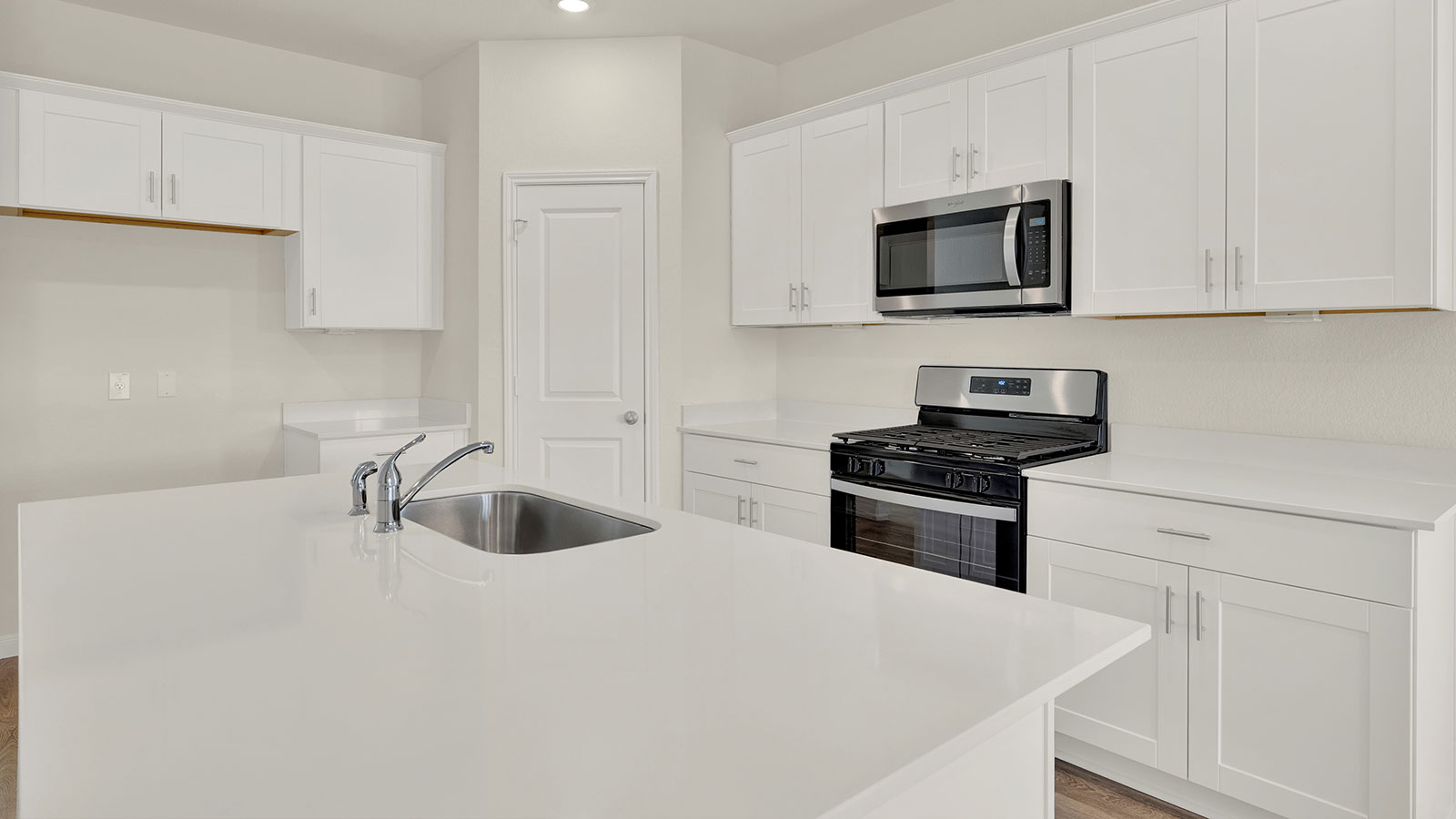 Kitchen with kitchen island and granite countertops.