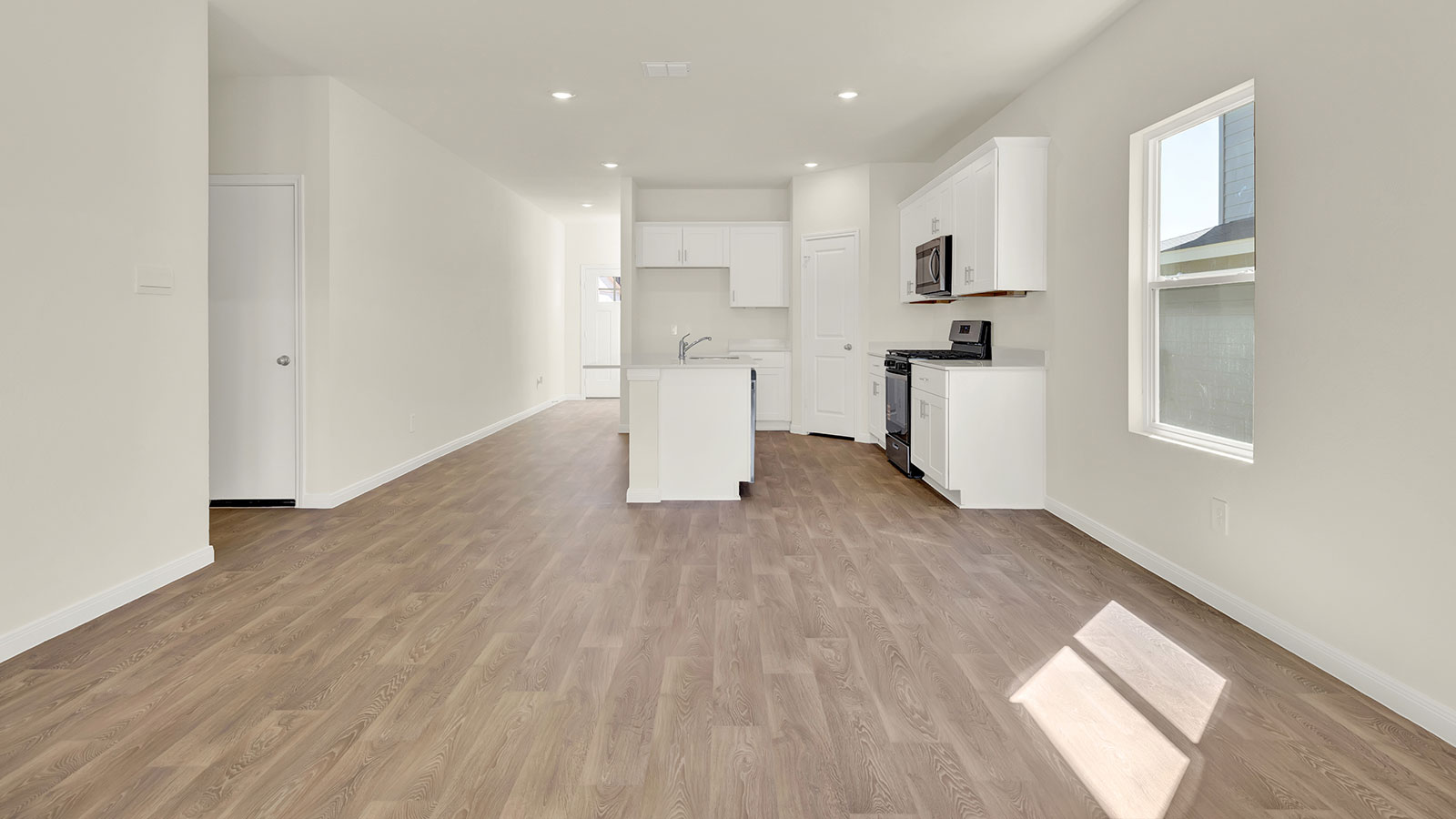 Living room, entry hallway, and kitchen.