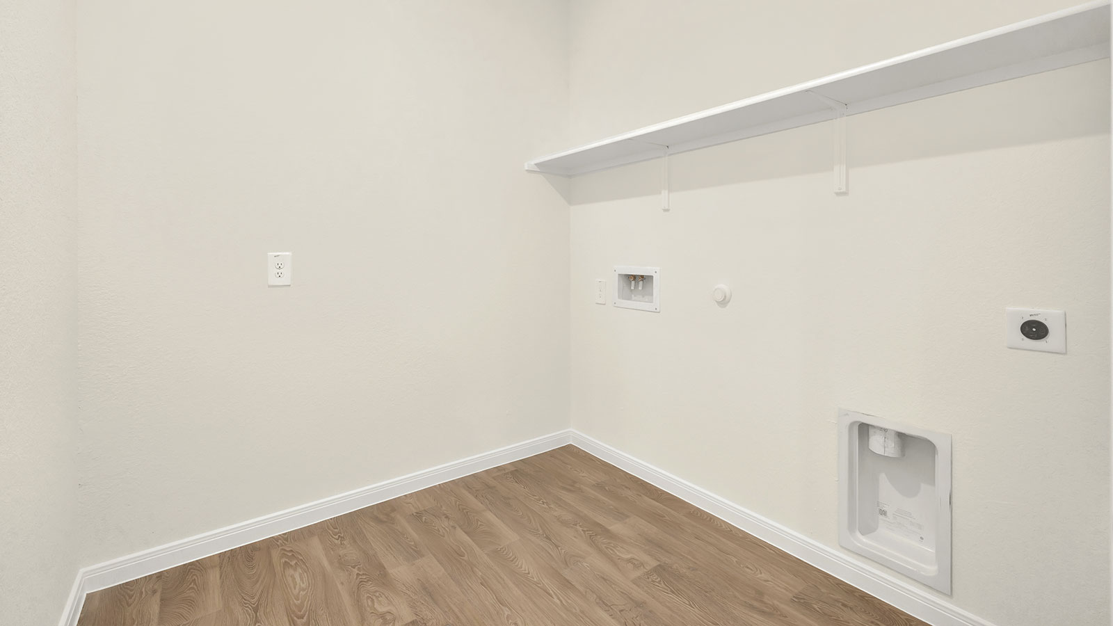 Laundry room with washer/dryer connections and wooden shelving.