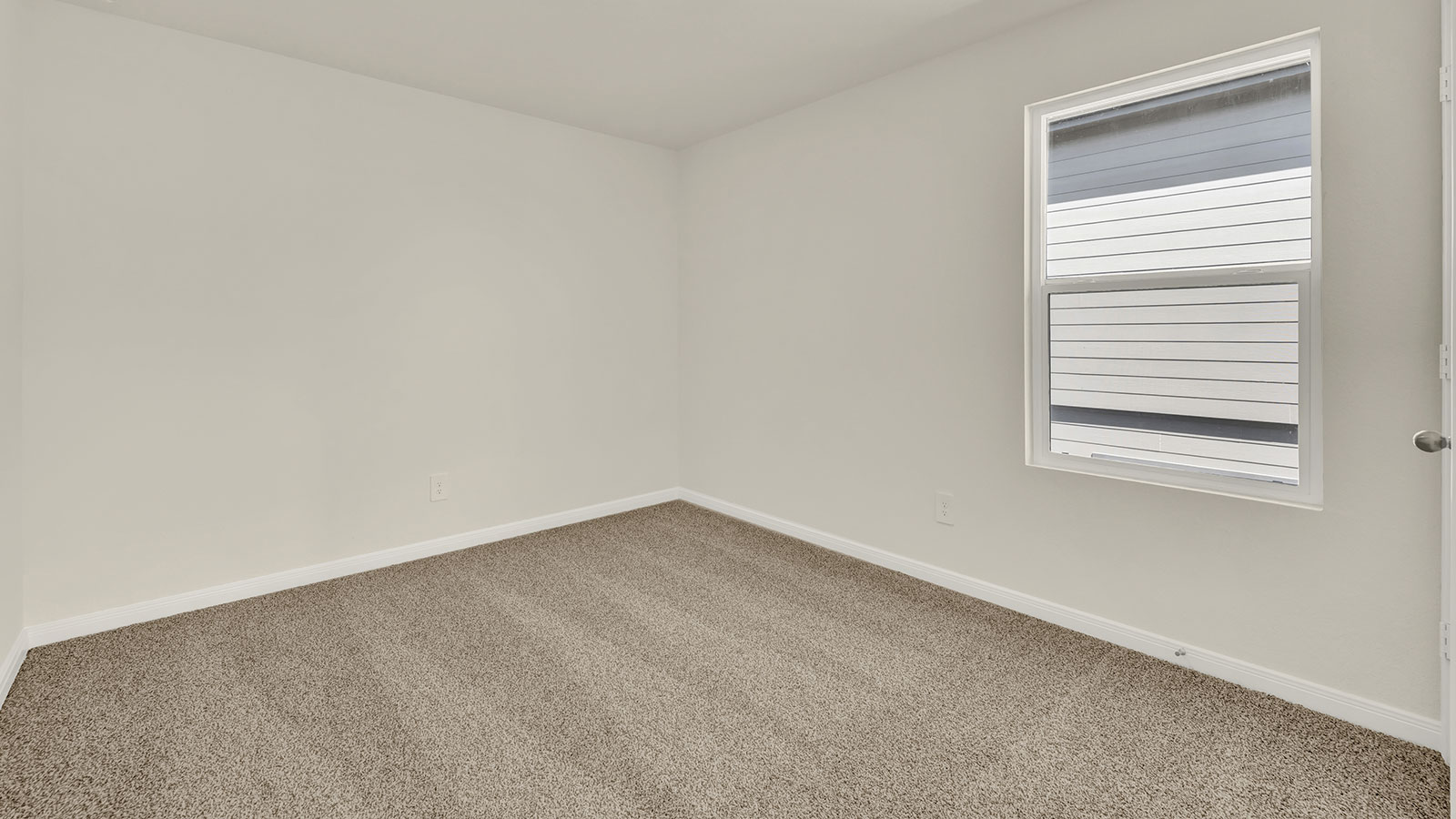 Bedroom with carpeting and one window.