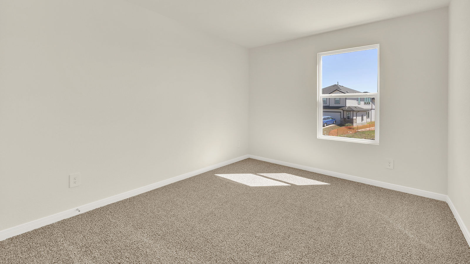 Bedroom with carpeting and one window.