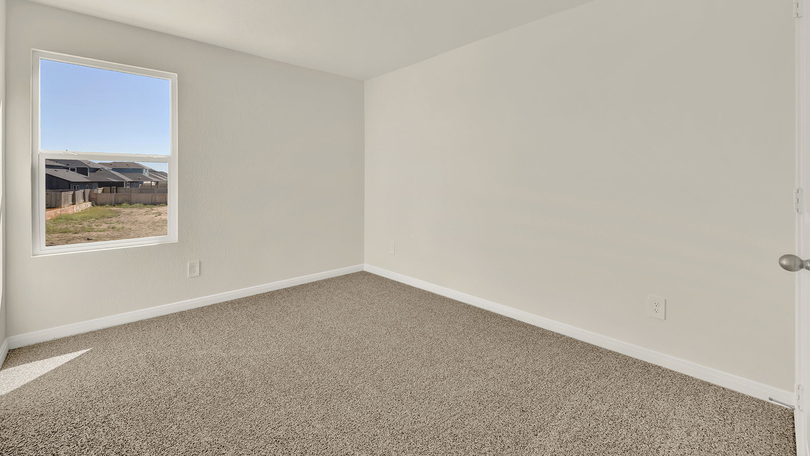 Bedroom with carpeting and one window.