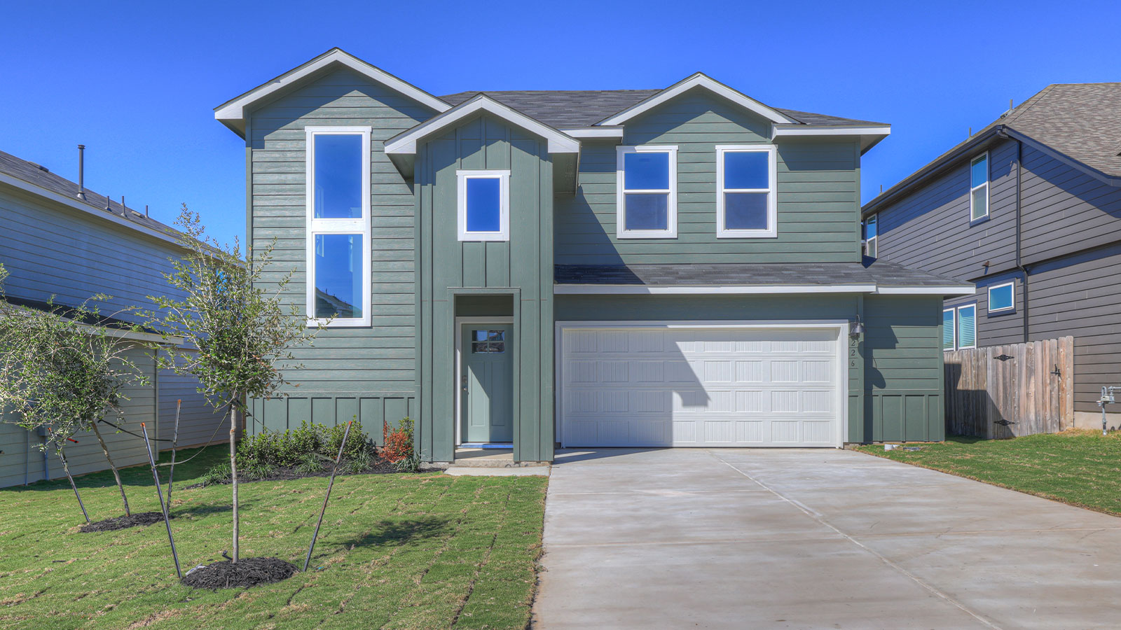 Two-story farmhouse exteriors with 2 car garage.
