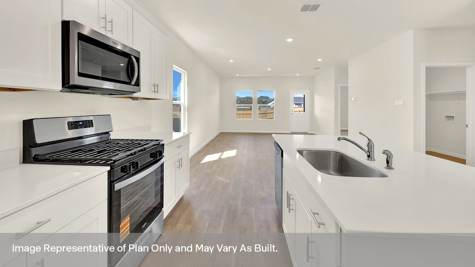 Kitchen with kitchen island and stainless steel appliances.