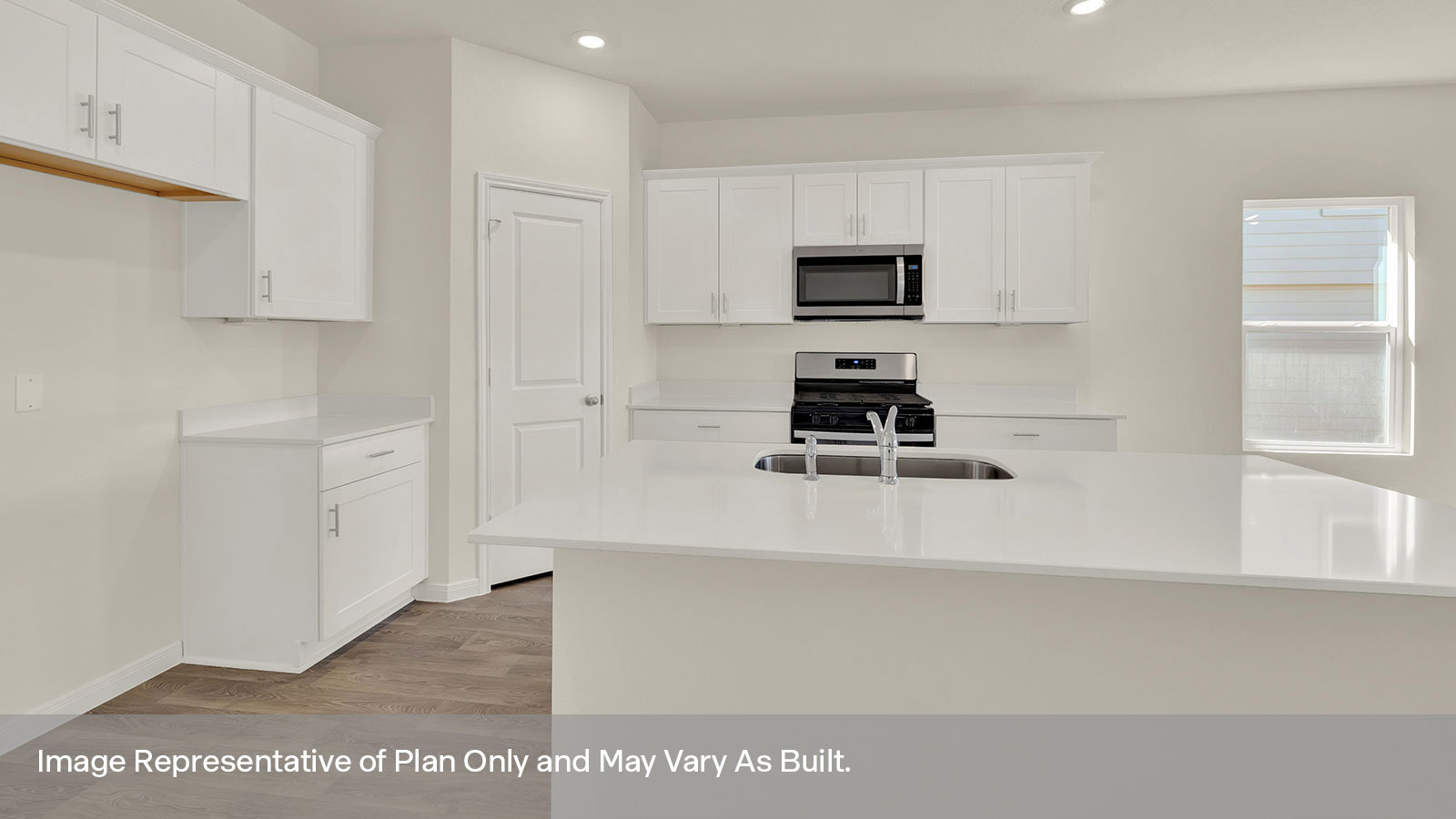 Kitchen with kitchen island and stainless steel appliances.