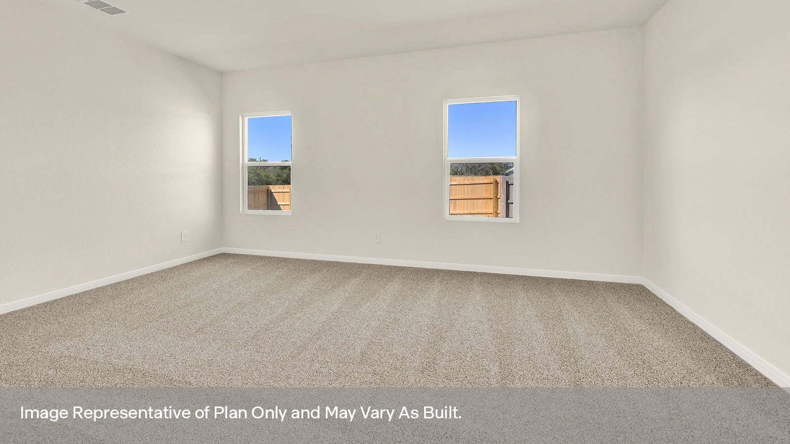 Main bedroom with carpeting and two windows.