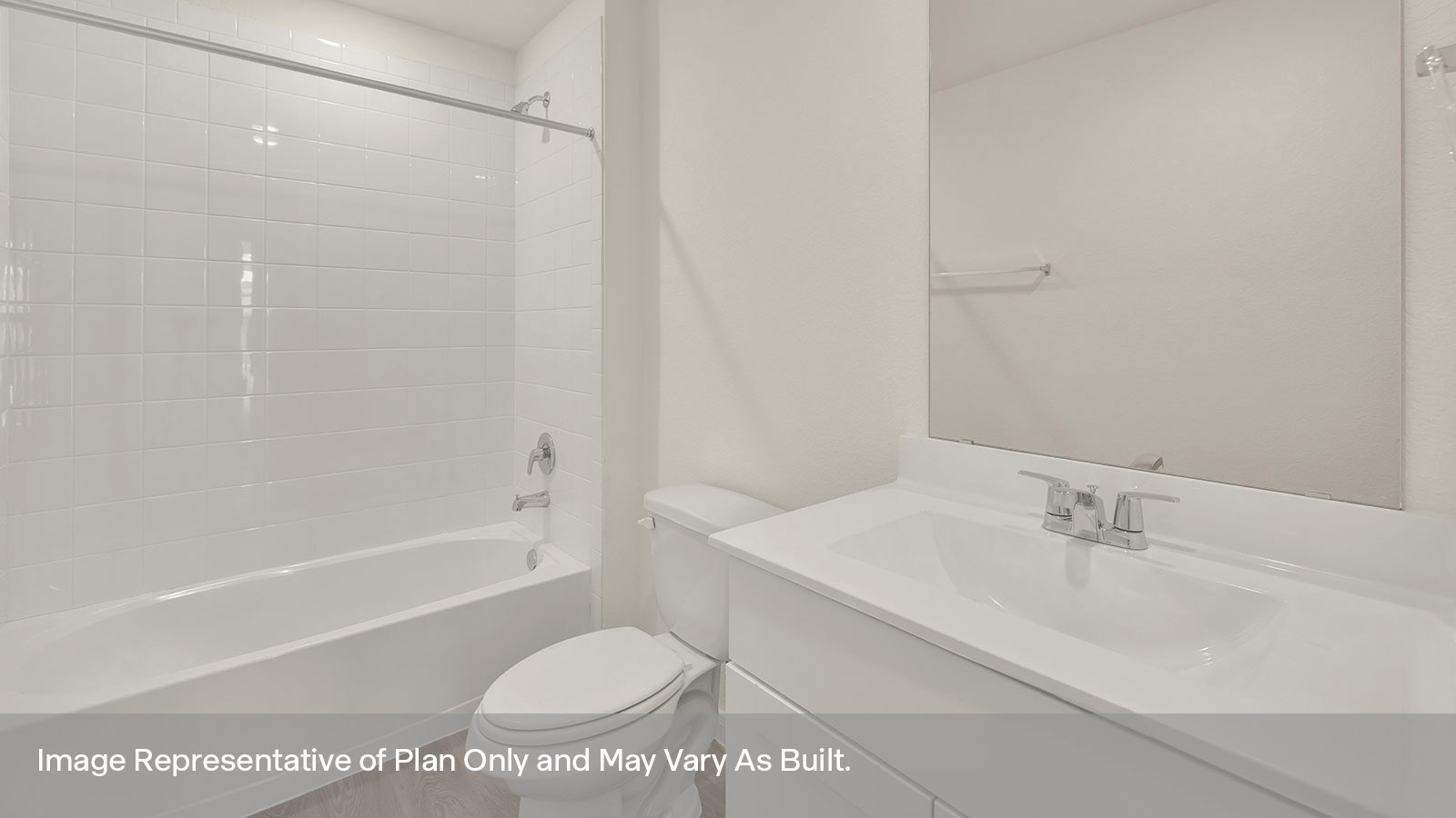 Hall bathroom with single sink vanity, toilet, and tub with tile surround.