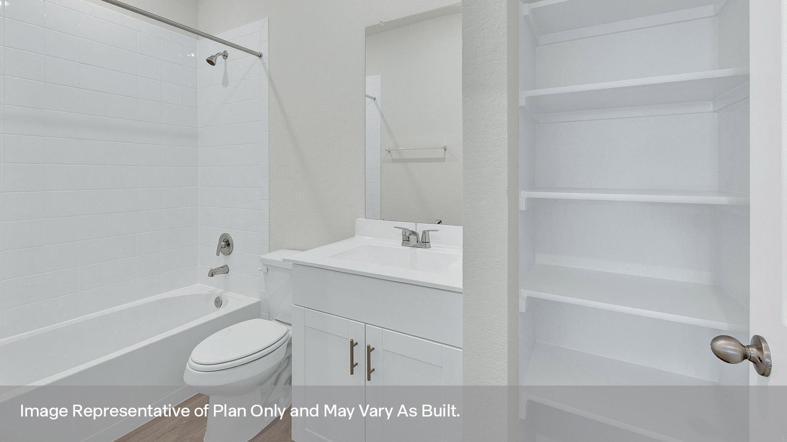 Hall bathroom with single sink vanity, toilet, and tub with tile surround.