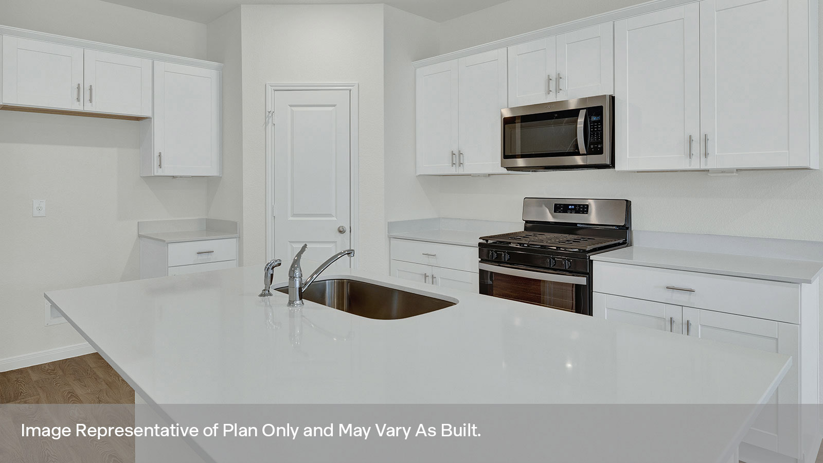 Kitchen with kitchen island, quartz countertops, and stainless steel appliances.