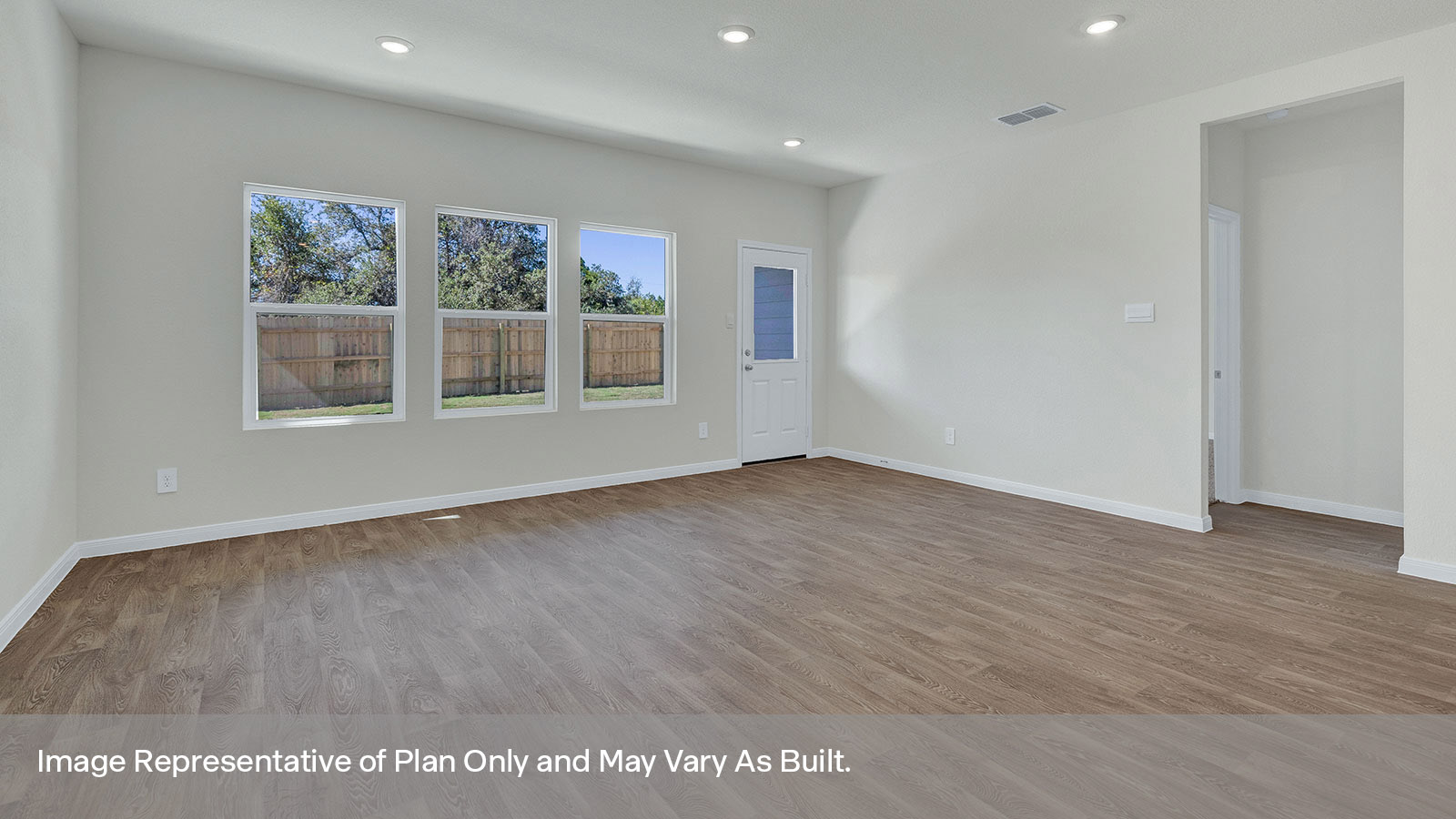 Living room with vinyl flooring, two windows, and a half lite exterior door.