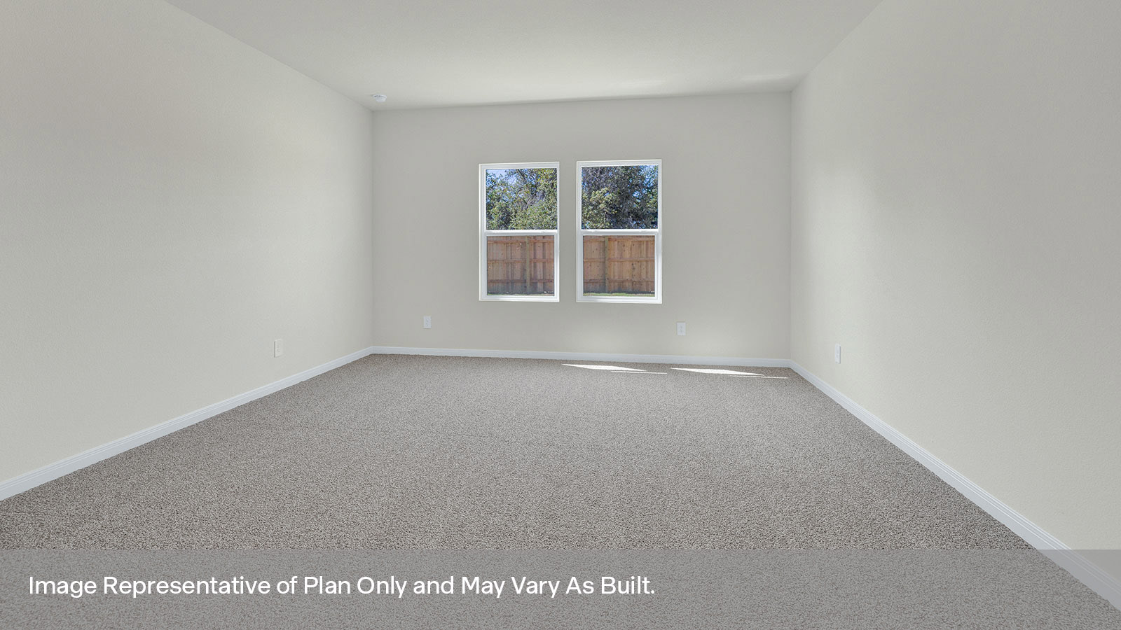 Main bedroom with carpeting and two windows.