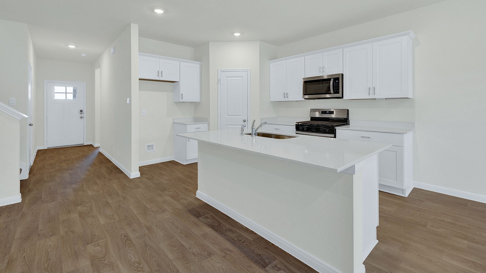 Kitchen island with granite countertops and stainless steel sink.