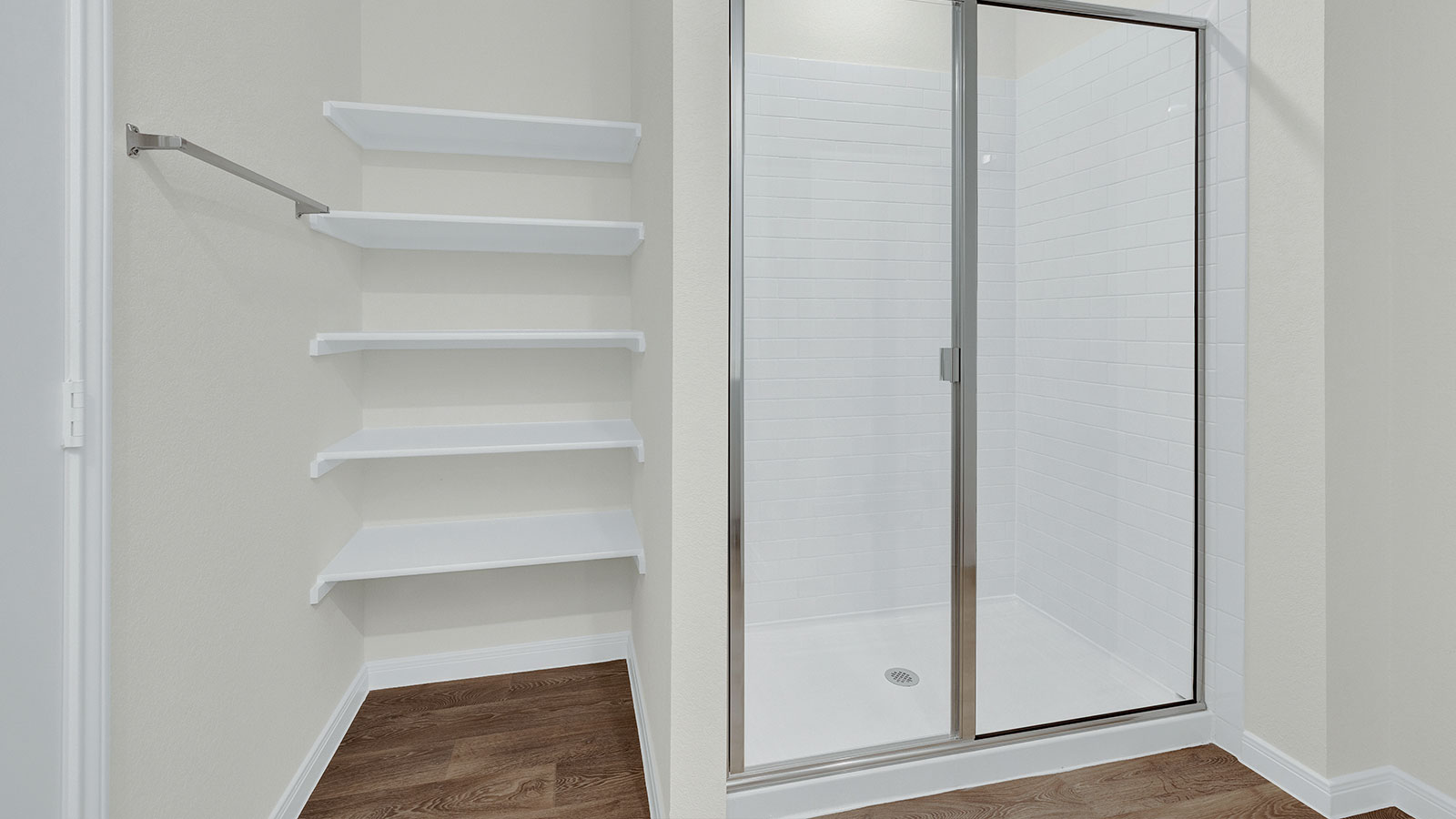 Main bathroom with walk-in shower with shower glass door and wooden shelving.