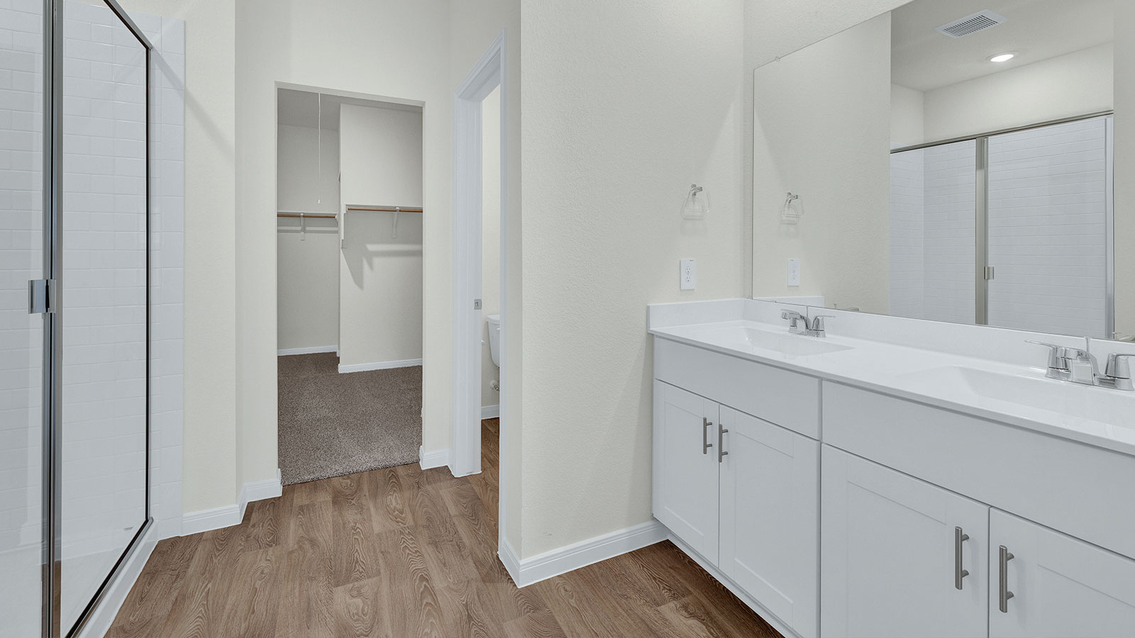 Main bathroom with walk-in shower with shower glass door.