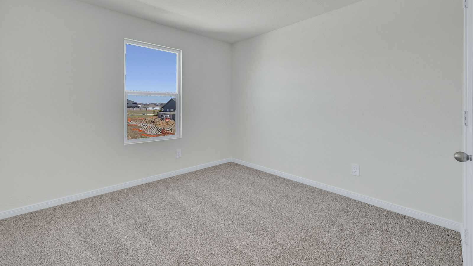 Bedroom with carpeting and one window.