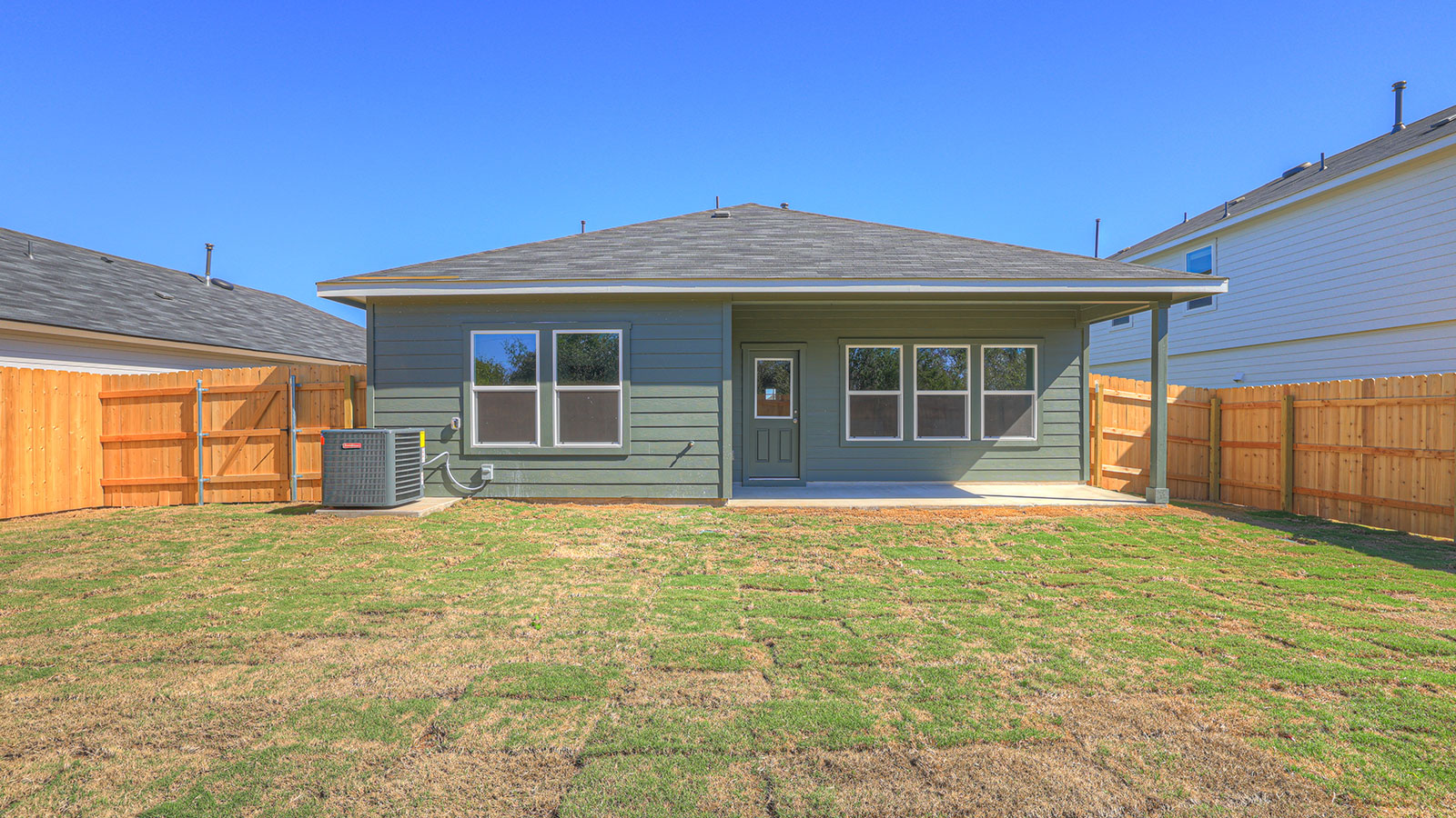 Covered patio with fully sodded yard and privacy fence.