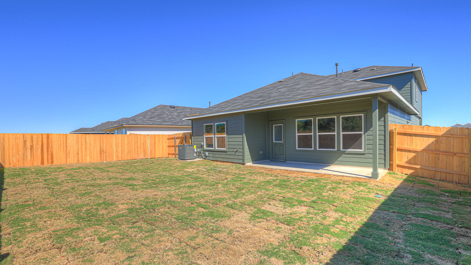 Covered patio with fully sodded yard and privacy fence.