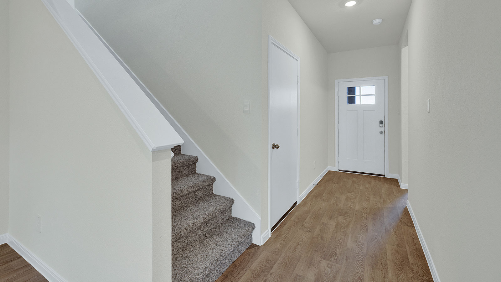 Entry showing the carpeted staircase.