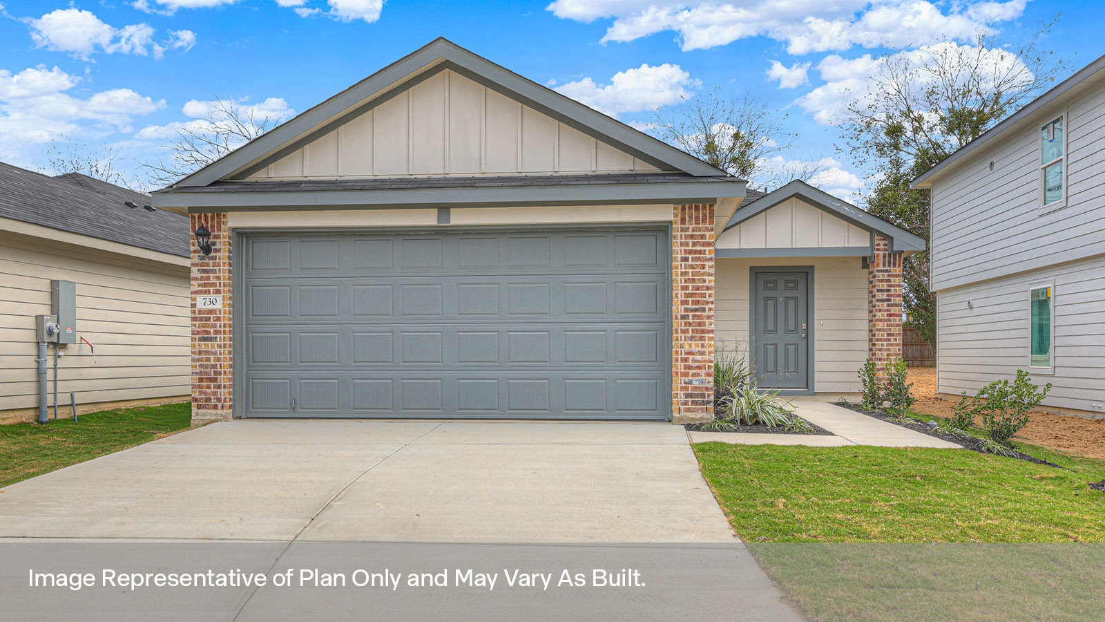 Two car garage, siding and a wrap around sidewalk to the front entry