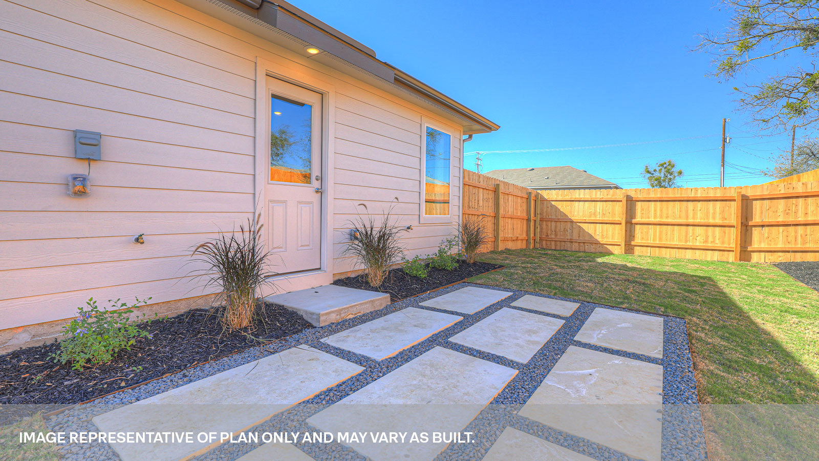 Backyard with 2 windows, and a half lite exterior door.