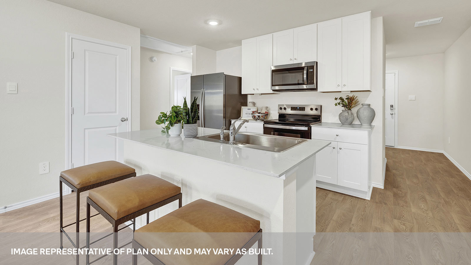 Kitchen with quartz countertops and stainless-steel appliances.