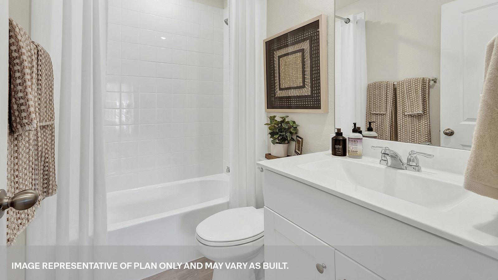 Hall bathroom with shower, toilet, and sink.