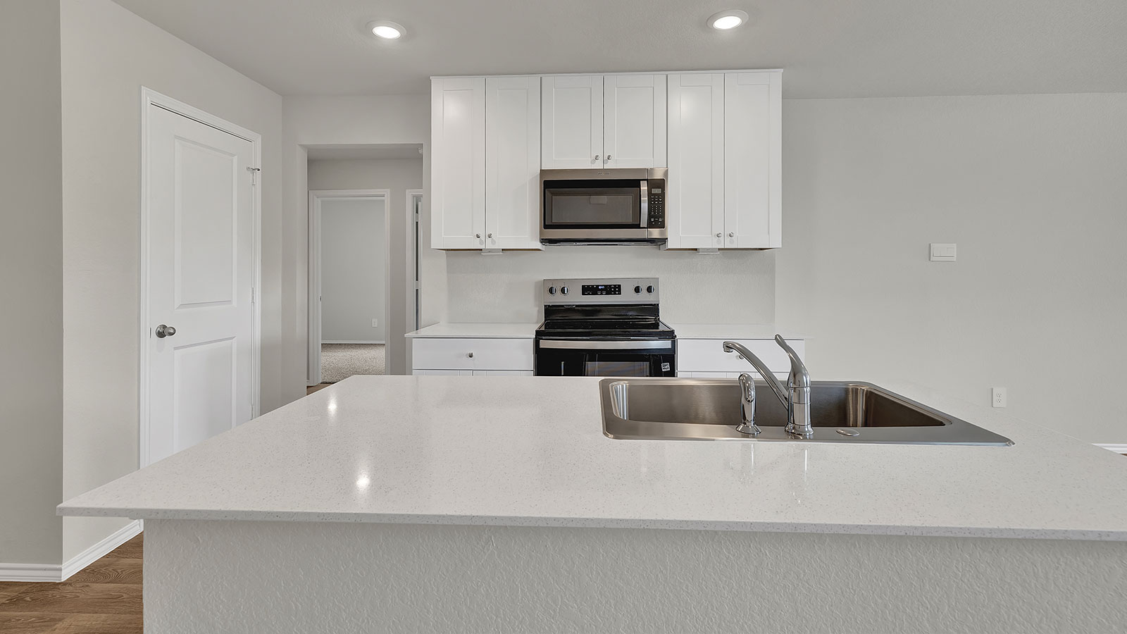 Kitchen with kitchen island overlooking the dining room and living room.