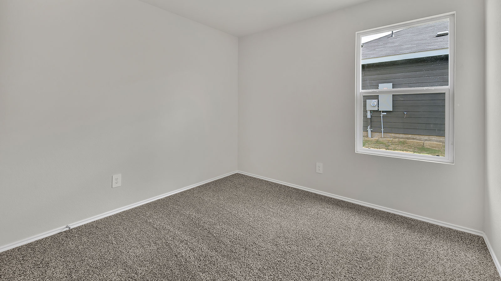Hall bedroom with carpeting and one window.