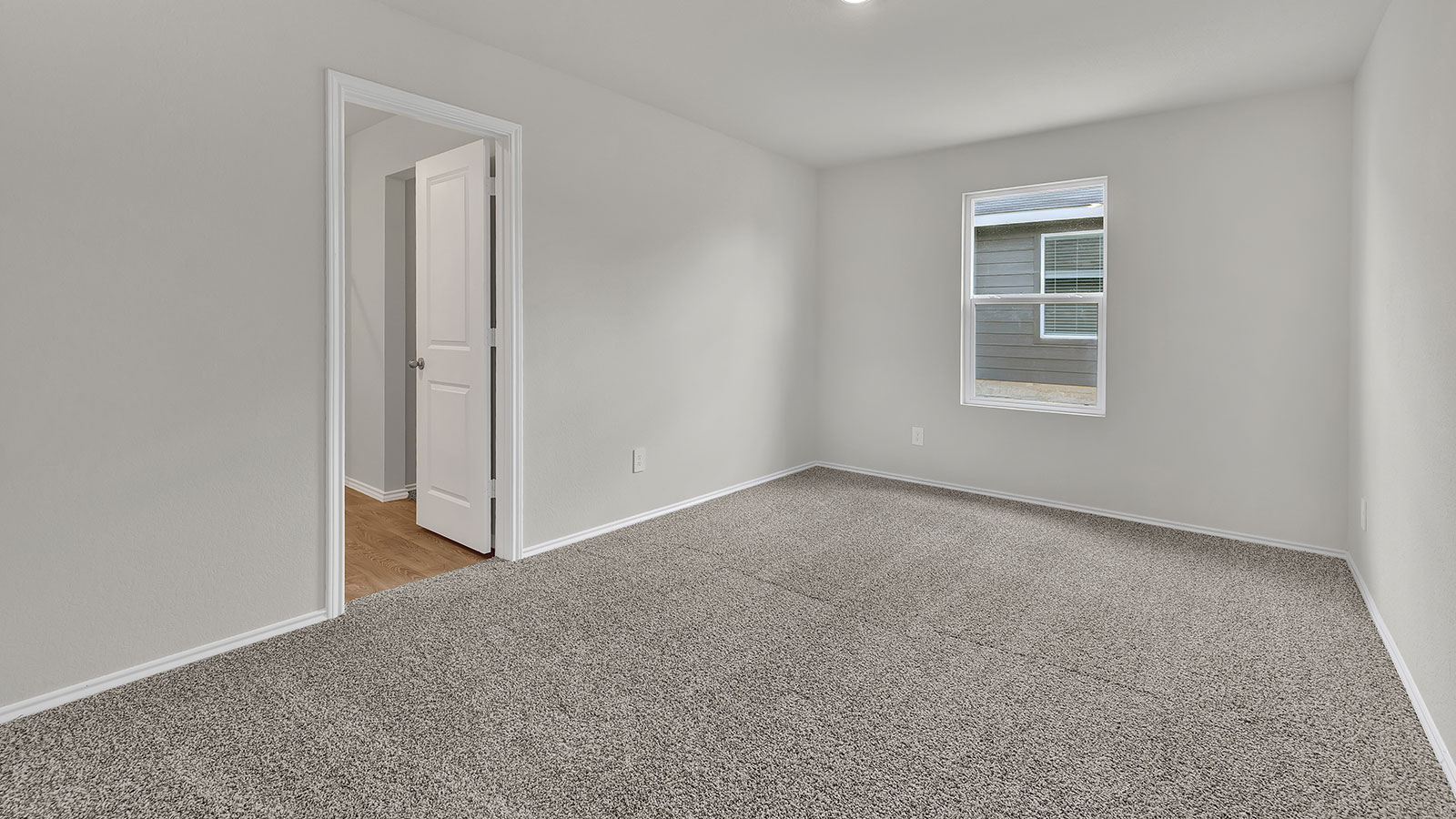 Main bedroom with carpeting and one window.