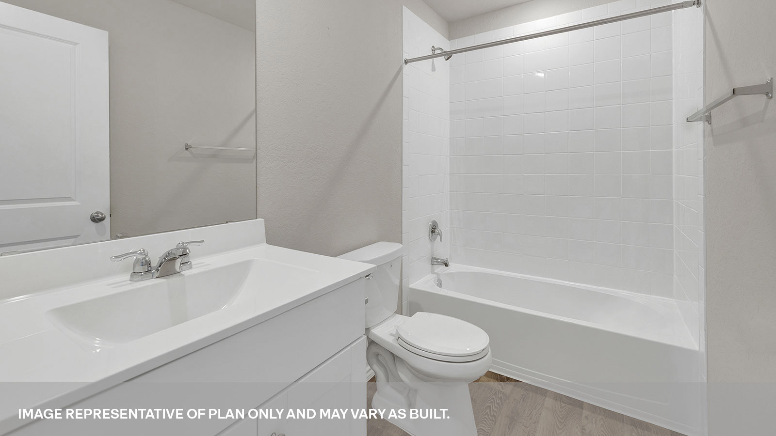Hall bathroom with vanity, toilet, and tub with tile surround.