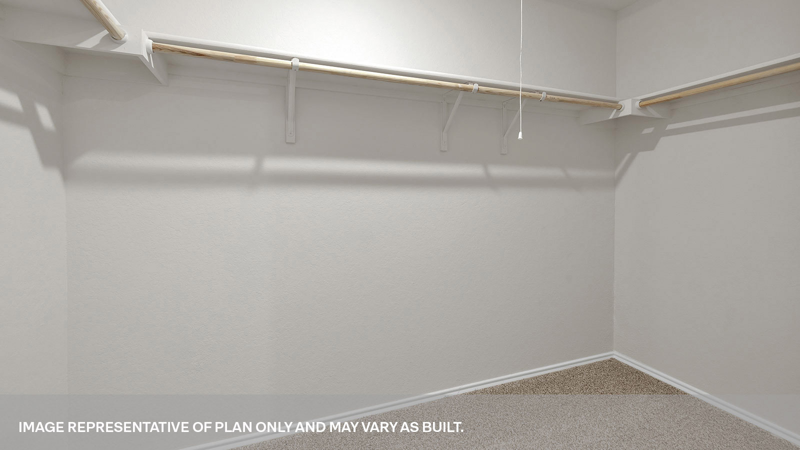 Main bedroom closet with carpeting and wooden shelving.